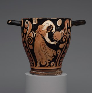 photo of a terracotta skyphos with a dancing maenad decoration
