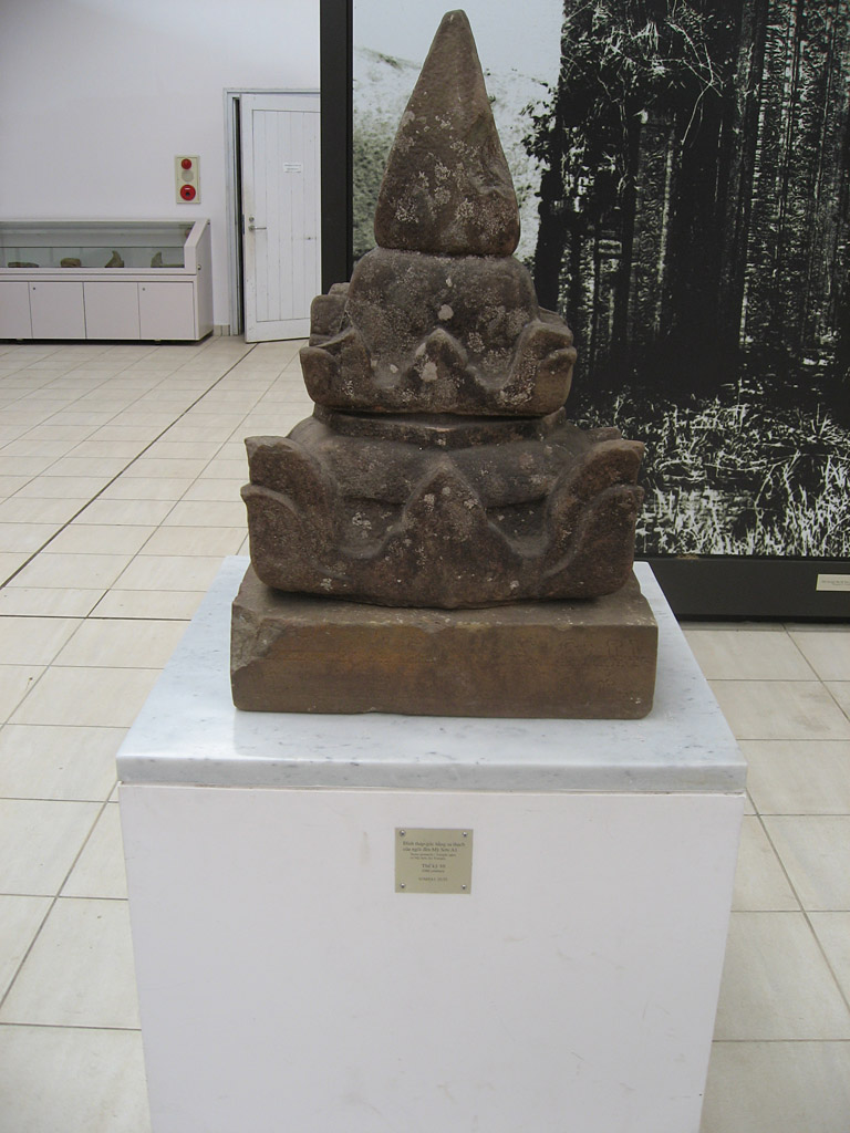 Photograph of the pedestal bearing inscription , displayed upside-down, and mounted by an unrelated object. Taken at Mỹ Sơn by Arlo Griffiths on .