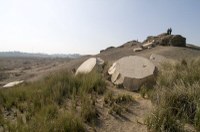 Limestone blocks (from large columns) on a hill at an archaeological site in Egypt.