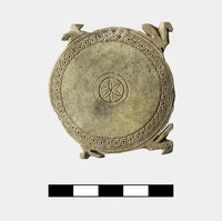 Stone disk with carved central rosette, decorative band, and four three-dimensional stylized birds around edge.