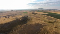 Tumulus tan and brown colored fields surrounding Gordion, central Türkiye, with the green “Midas Mound” at center.