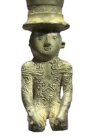 bronze figure of a man with tattoo like line designs on the body