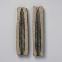 Two bronze-casting molds on a gray background