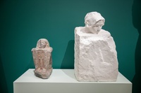 Photo of ancient Egyptian block statue next to a Rodin sculpture with a similar shape in the ISAW galleries