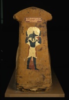 Foot end of an Egyptian mummy showing Anubis facing right with solar disk above him and a Greek inscription.