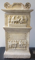 marble funerary altar with carved reliefs in two registers showing scribes writing above and a crowd gathered below; in the middle a Latin inscription to the deceased.