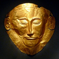 Photo of gold mask showing a man's face with closed eyes and a beard