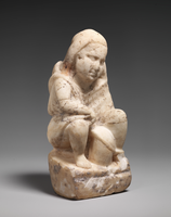 Small stone statuette of a seated person 