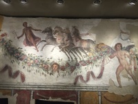 Fresco on a tomb wall in Tyre showing Hermes leading an individual (no longer extant) in a four horse chariot into the afterlife. Names are painted above the figures' heads in Greek to identify them.