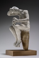 Seated plaster figure in a contemplative pose, head bowed and arms folded, mounted on a narrow pedestal.