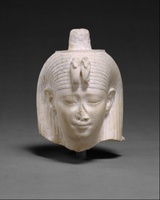 Fragmentary limestone sculpture depicting a woman's head in an ancient Egyptian style