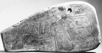 Stylized image of a tiger in relief on a portable stone object with a drilled hole for hanging