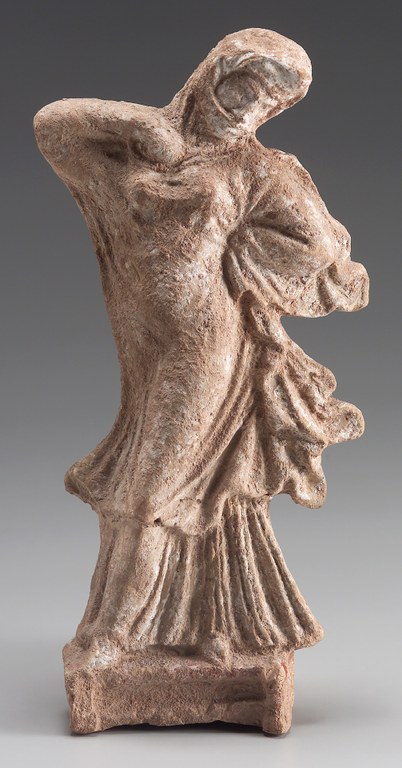 Statuette of a veiled woman, wearing a long dress, dancing.
