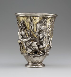 Silver and gold beaker with seated and standing male and female figures in repoussé.