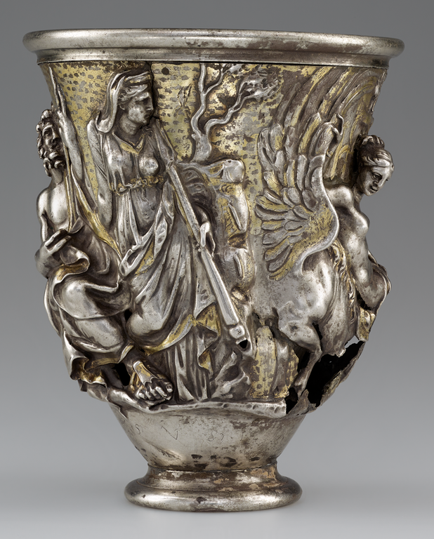 Photograph of a silver and gold beaker, richly decorated with figures in raised relief.