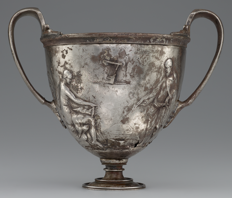 Photograph of a silver, two-handled cup decorated with male figures