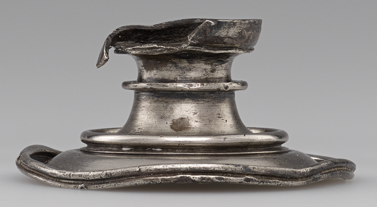 Photograph of a damaged silver foot from a cup