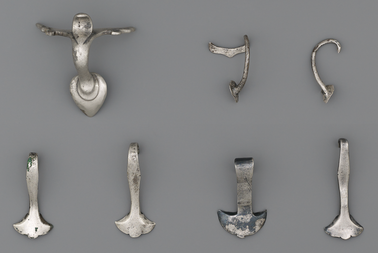 Photograph of six silver handles, one of them broken into two parts.