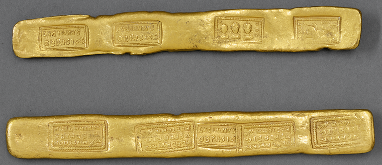 Photograph of two rectangular gold ingots, the first showing four stamps and the second showing five.