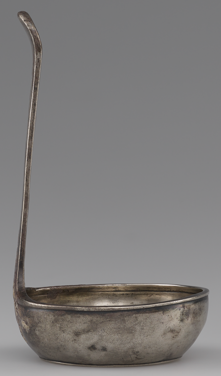 Photograph from the side of a silver ladle
