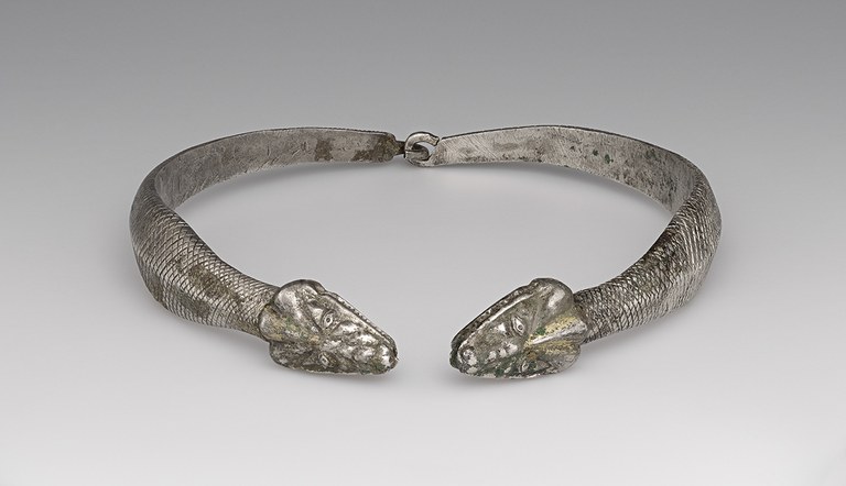 linked pair of curved silver pieces, shaped like snakes