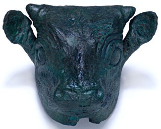 Photograph of a three-dimensional model of a bull's head in a shiny, nearly black material. The bull faces the viewer. Short horns, prominent ears, and large eyes are evident.