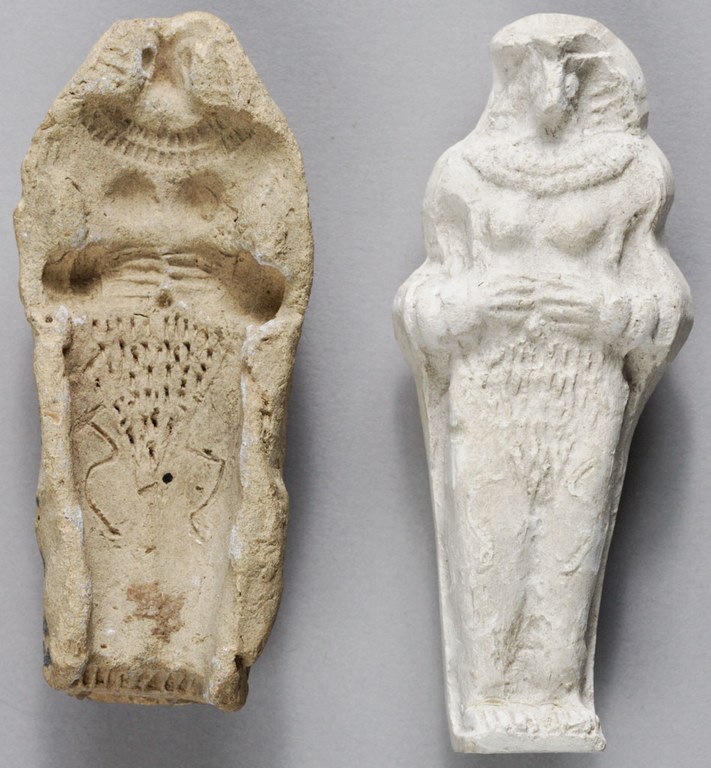 Mold of a standing female figure and its cast. The figure clasps her hands together above her waist and wears a textured skirt.