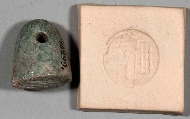 Stamp seal and impression of a priest or sage worshiping the divine symbols of a spade and stylus. The stamp seal is made of a vitreous material and is greenish gray in color.