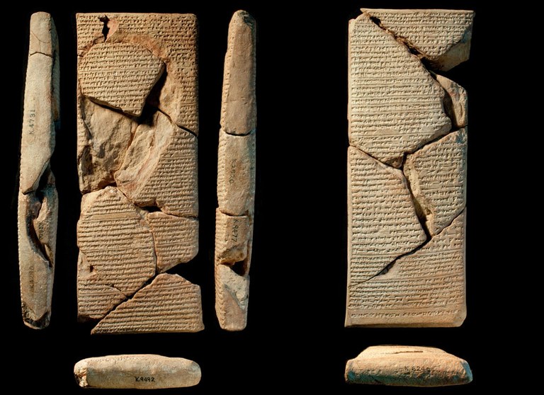 Fragmentary and cracked pieces of tablet with cuneiform inscriptions. The tablet is a brownish color.