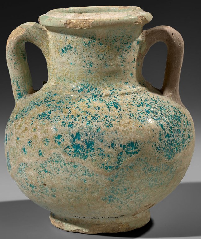 A blue glazed clay vessel with handles on both sides. The vessel has a rounded base and a broad mouth.