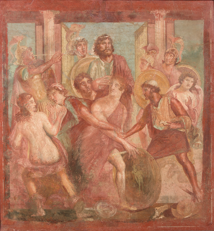 Deidamia, the daughter of Lycomedes, is at the center. Her right arm is grabbed by Achilles, who is behind her and reaches for his shield, which stands upright in front of Deidamia. At her left is Odysseus, who wears a small skullcap and holds a short spear in his left hand. Behind Deidamia and seated or standing just above her, King Lycomedes calmly surveys the scene. At his right a helmeted solder blows a trumpet as the sign of an impending battle. Other helmeted soldiers crowd the background.