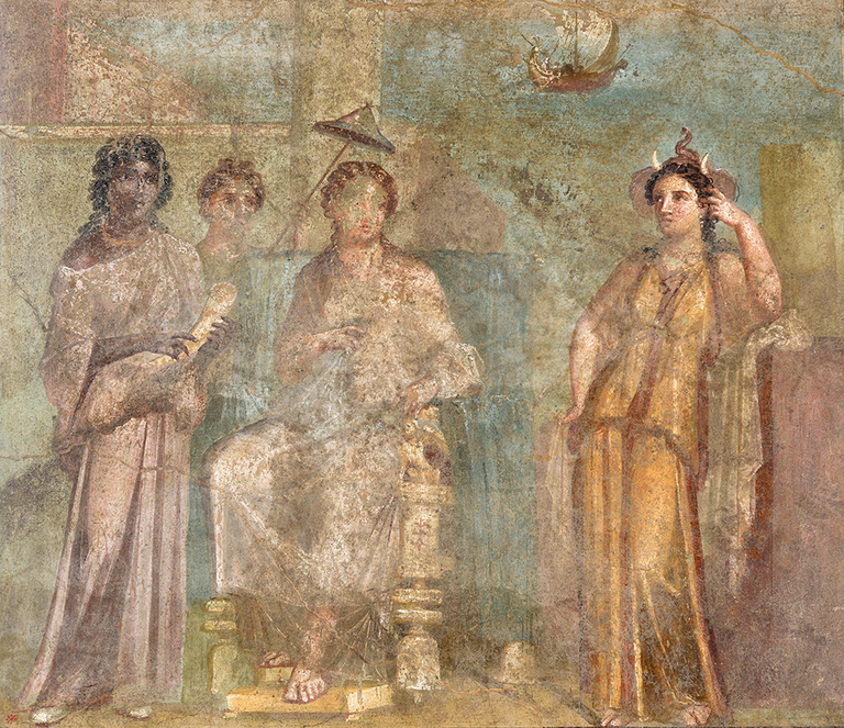 Queen Dido of Carthage sits enthroned at center while a small ship sails off in the distant background in the top left. A dark-skinned woman at left holds an ivory drinking vessel shaped like a tusk, and the light-skinned female figure at right wears an elephant headdress. A woman behind the throne holds a small parasol over the queen’s head.