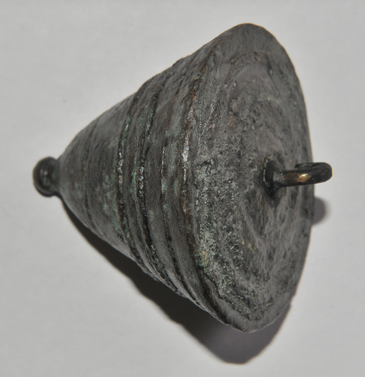 A cone-shaped piece of bronze with a small ball on the base and knob at the apex.