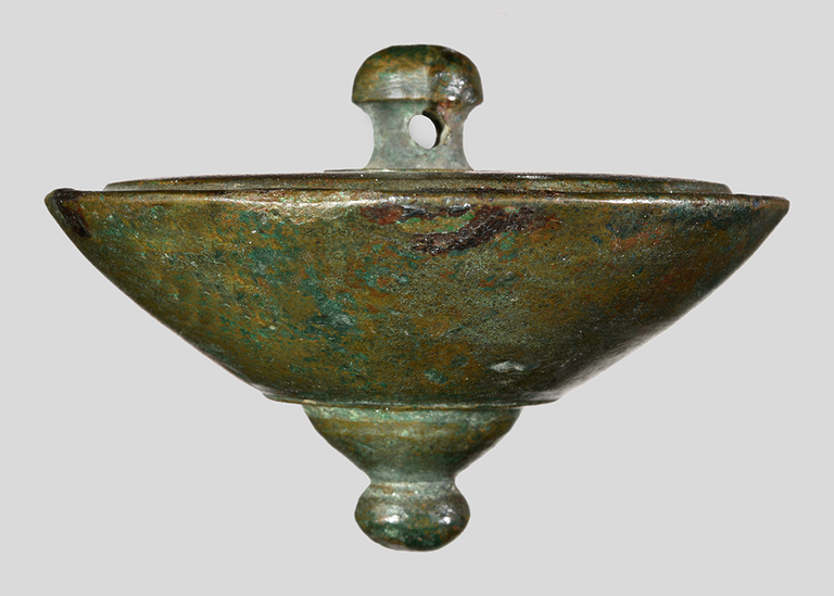 This solid bowl-shaped piece of bronze has a mushroom-shaped knob on the base and a knob above a small, inverted bowl shape that forms the apex.