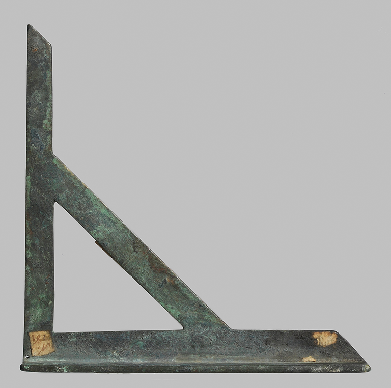 Two rectangular pieces of bronze are joined at a right angle. A third piece is attached to the other two at the midpoint of each, creating a right-angle triangle.