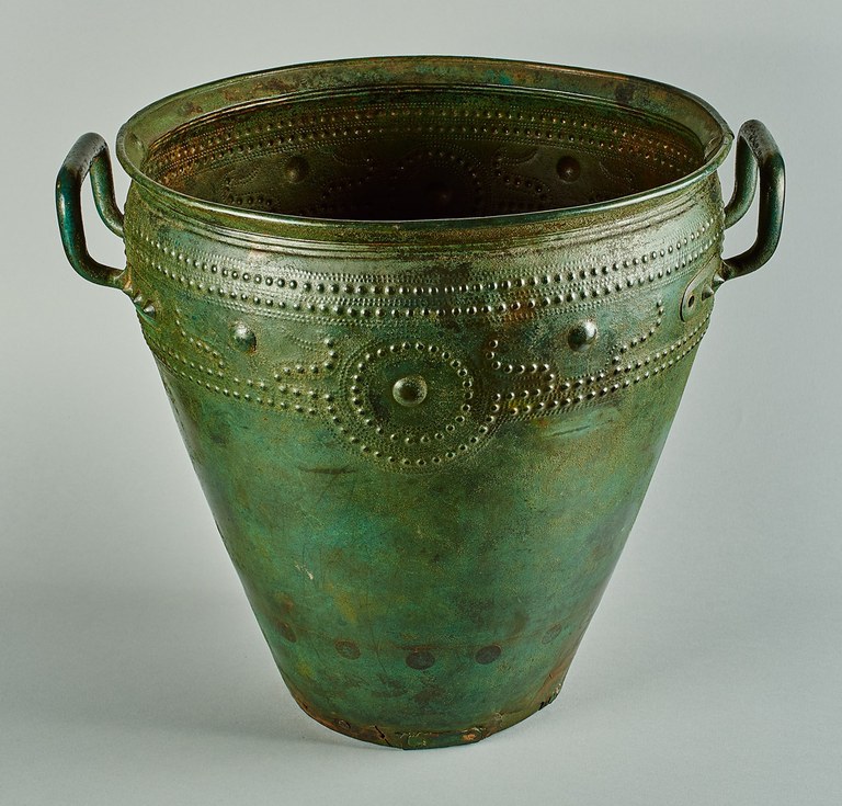 A bucket-shaped vessel with two handles and decorated with patterns of small and large raised dots.