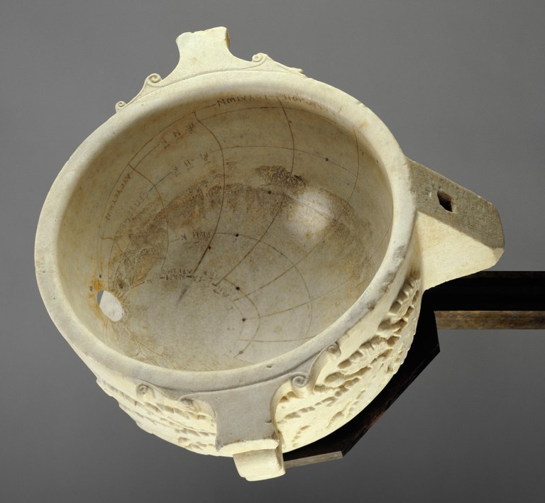 Image of a large marble cup or bowl with inscribed lines and Greek labels on the inside. A hole through the side allows sunlight from outside to indicate the time on the inscribed lines.