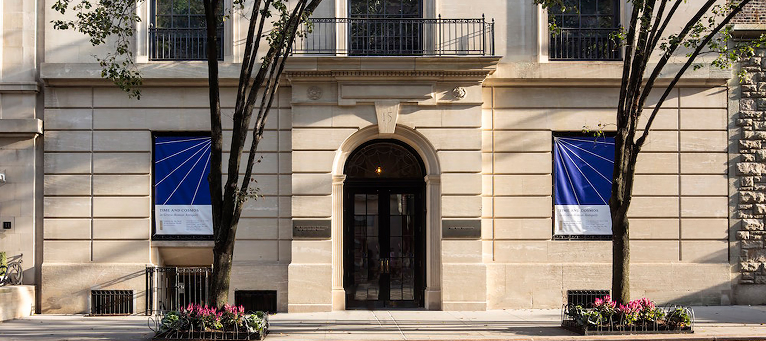 photo of the building at 15 east 84th street showing blue banners in the windows