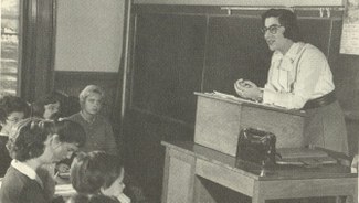 Prof. Nina Garsoïan, standing at a lectern in a classroom of students at Smith College, 1958.