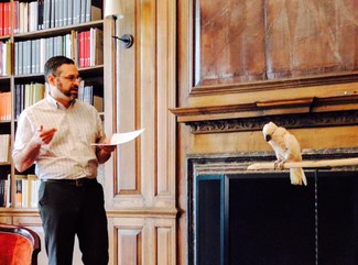 Patrick Burns reading to a parrot