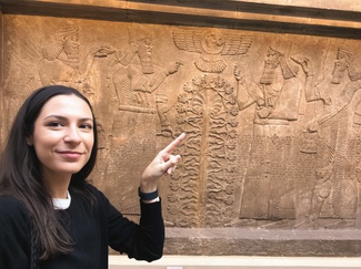 A photo of Samantha Rainford pointing at a wall 