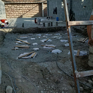 Construction site showing the tips of several wine vessels buried underground