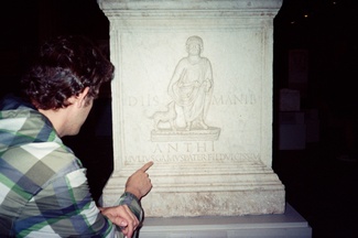 Javier pointing at a tombstone