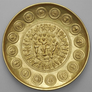 A gold bowl depicting Bacchus and Hercules surrounded by mounted coins