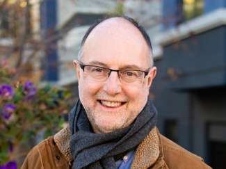 A portrait photo of Greg Woolf