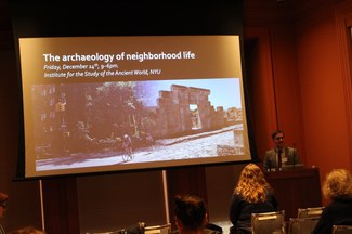 Andrew Dufton introduces a session in front of a screen that reads "the archaeology of neighborhood life"