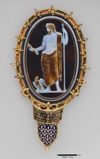 A small gem set in a gold mount depicting Jupiter with a scepter and eagle