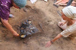 Restorers consolidating a wooden plaque, Hissorak 2013. Photograph courtesy of Judith A. Lerner