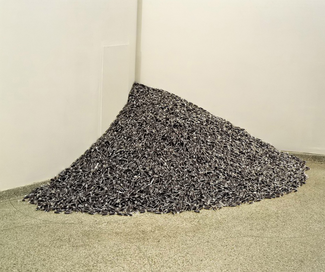 Photograph of a pile of blue-gray pieces of candy in a corner.