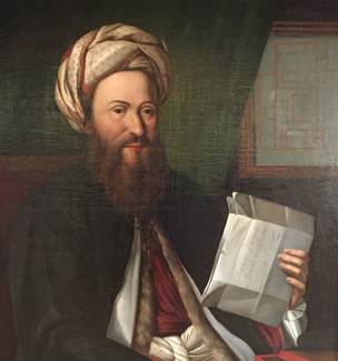 A portrait painting shows a seated, bearded man in a turban and long flowing clothes. He holds up a few creased pieces of paper with writing on them.